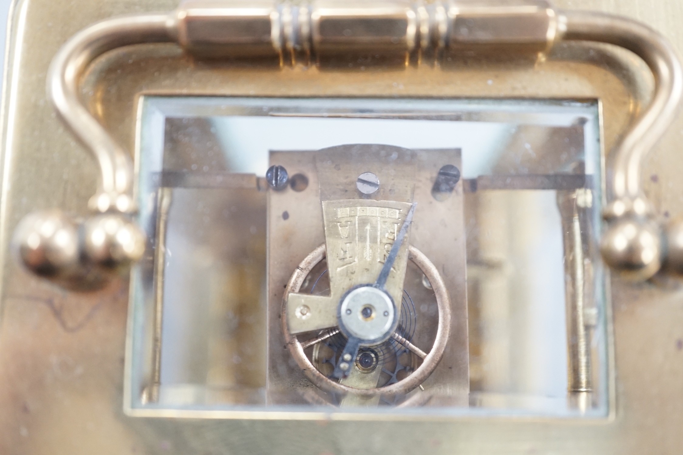 A brass cased carriage timepiece with key